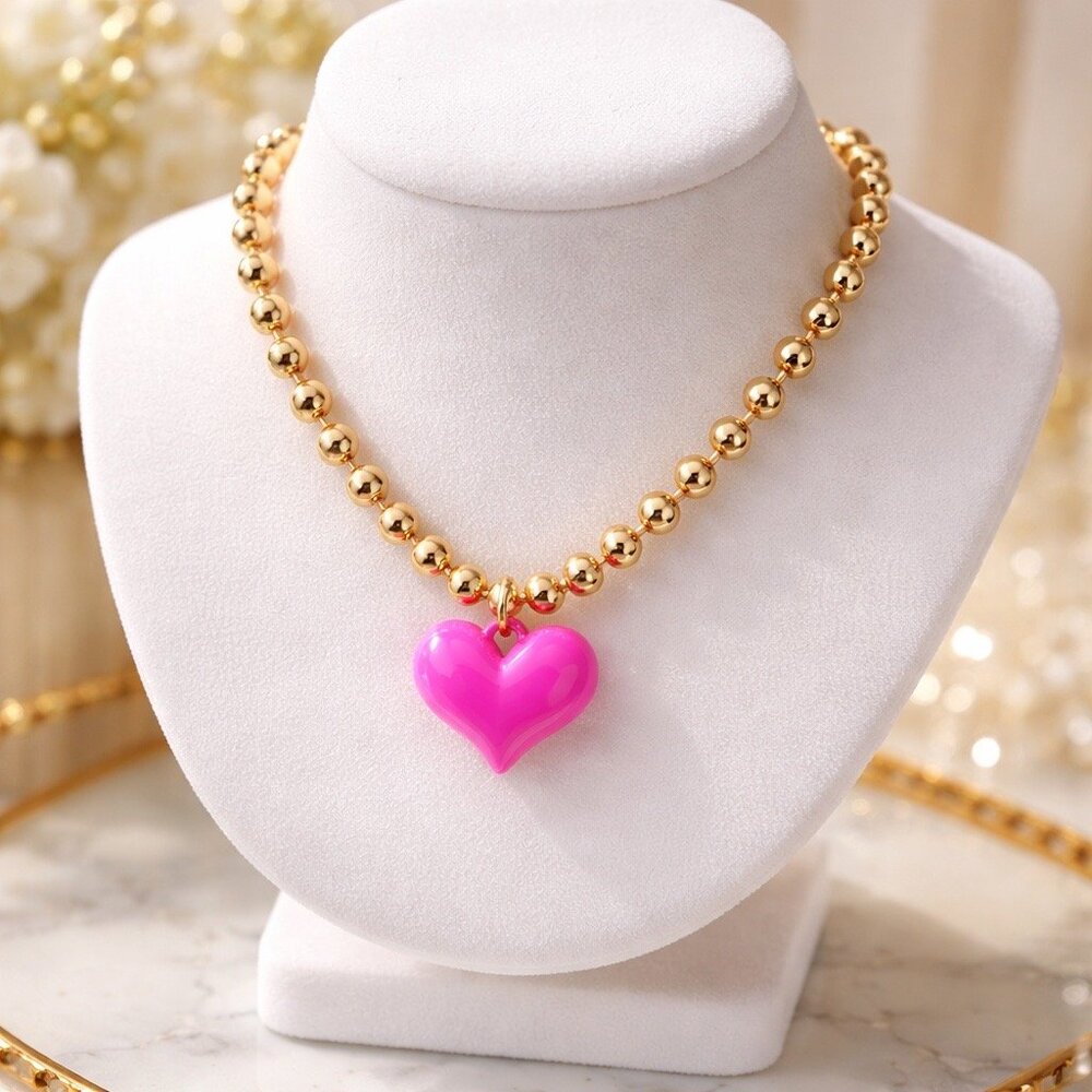 Gold tone ball chain necklace with bright pink puffy heart pendant